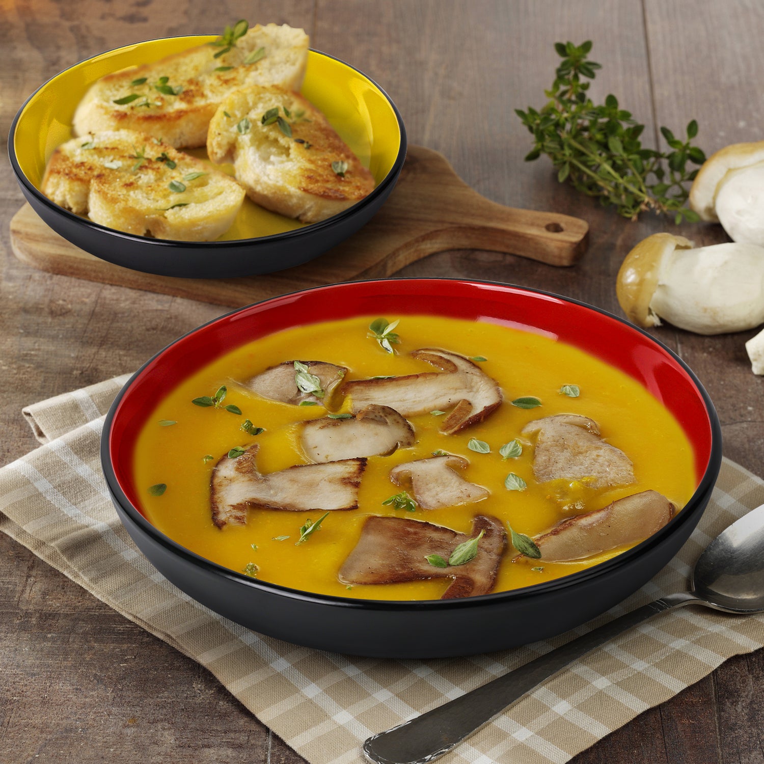 Suppe mit angebratenen Pilzen und Brot serviert in tiefen Tellern von MIAMIO auf gedecktem Tisch
